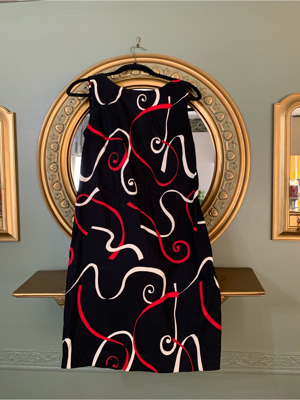 Sleeveless Black Dress with Red & White Swirl Pattern